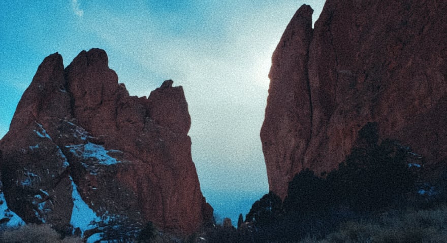 Grainy mountain view with a gap in the cliff face